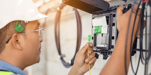 Technician inspecting fiber optic cable.